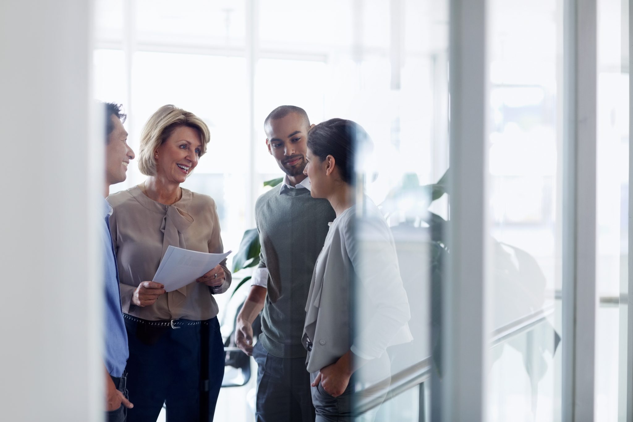 four persons talking with each other about customer retention